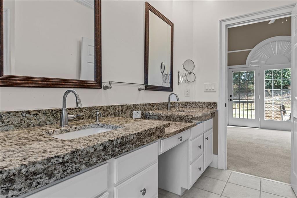 168 Jersey Road Oxford, GA 30054 - Photo 32 of 59 a bathroom with a granite countertop sink and a mirror