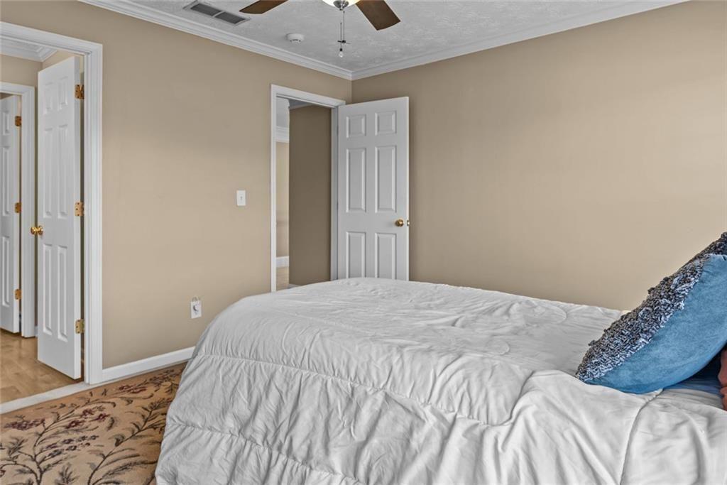 168 Jersey Road Oxford, GA 30054 - Photo 50 of 59 a bedroom with a bed and wooden floor