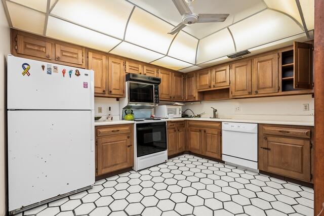 100 Worth Avenue, Unit 415 Palm Beach, FL 33480 - Photo 7 of 34 a kitchen with a refrigerator a stove top oven cabinetry a sink and a refrigerator