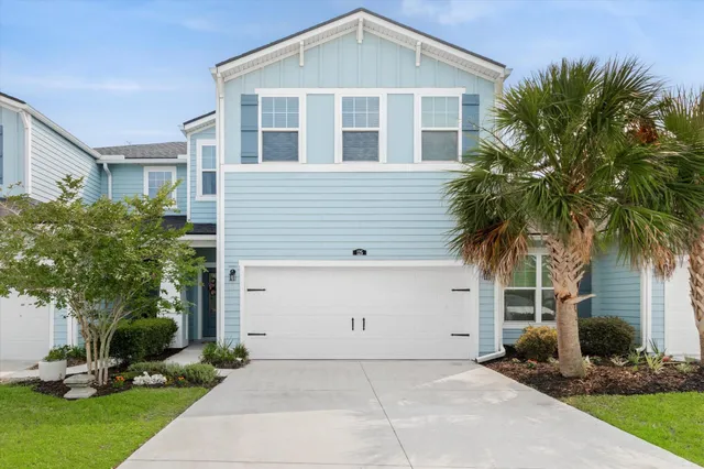 a front view of house with yard and trees