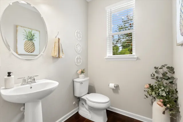 a bathroom with a sink mirror and toilet