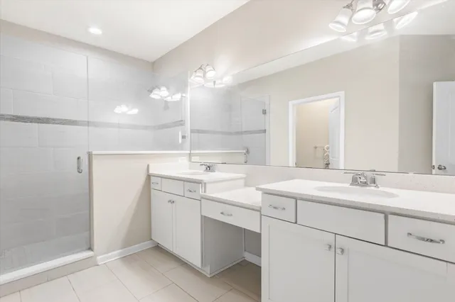 a bathroom with a sink a vanity a lamp and a mirror