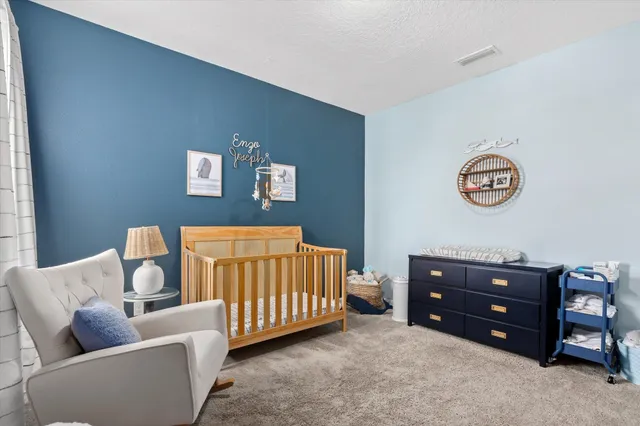 a bedroom with a bed and a couch