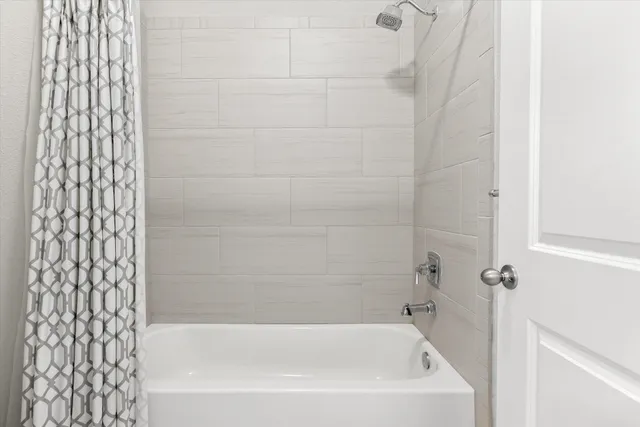 a close up of a bathtub curtain