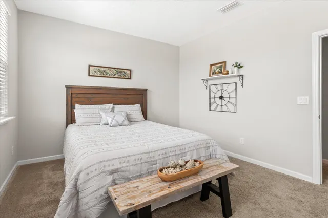 a bedroom with a bed and a table in it