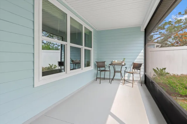 a balcony with table and chairs