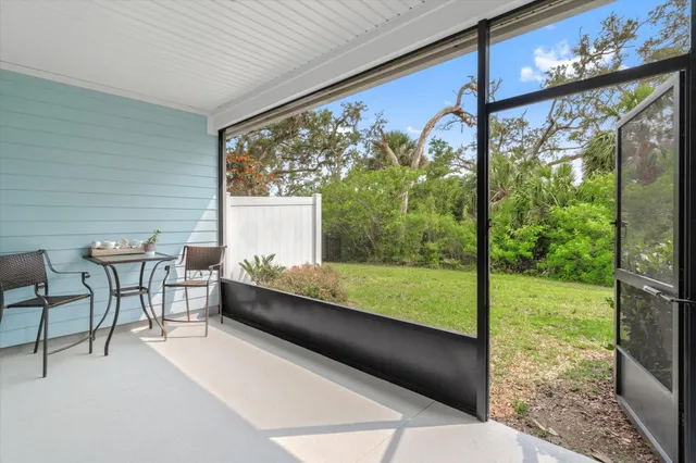 a view of a porch with furniture and garden