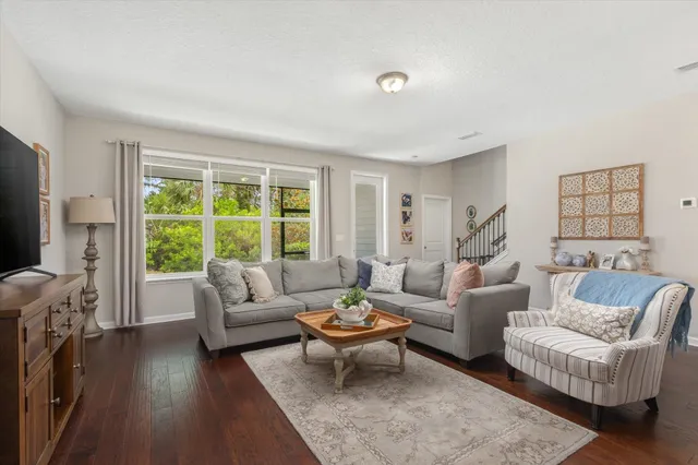 a living room with furniture and a large window