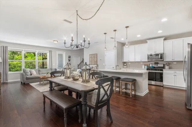 a large kitchen with a table and chairs