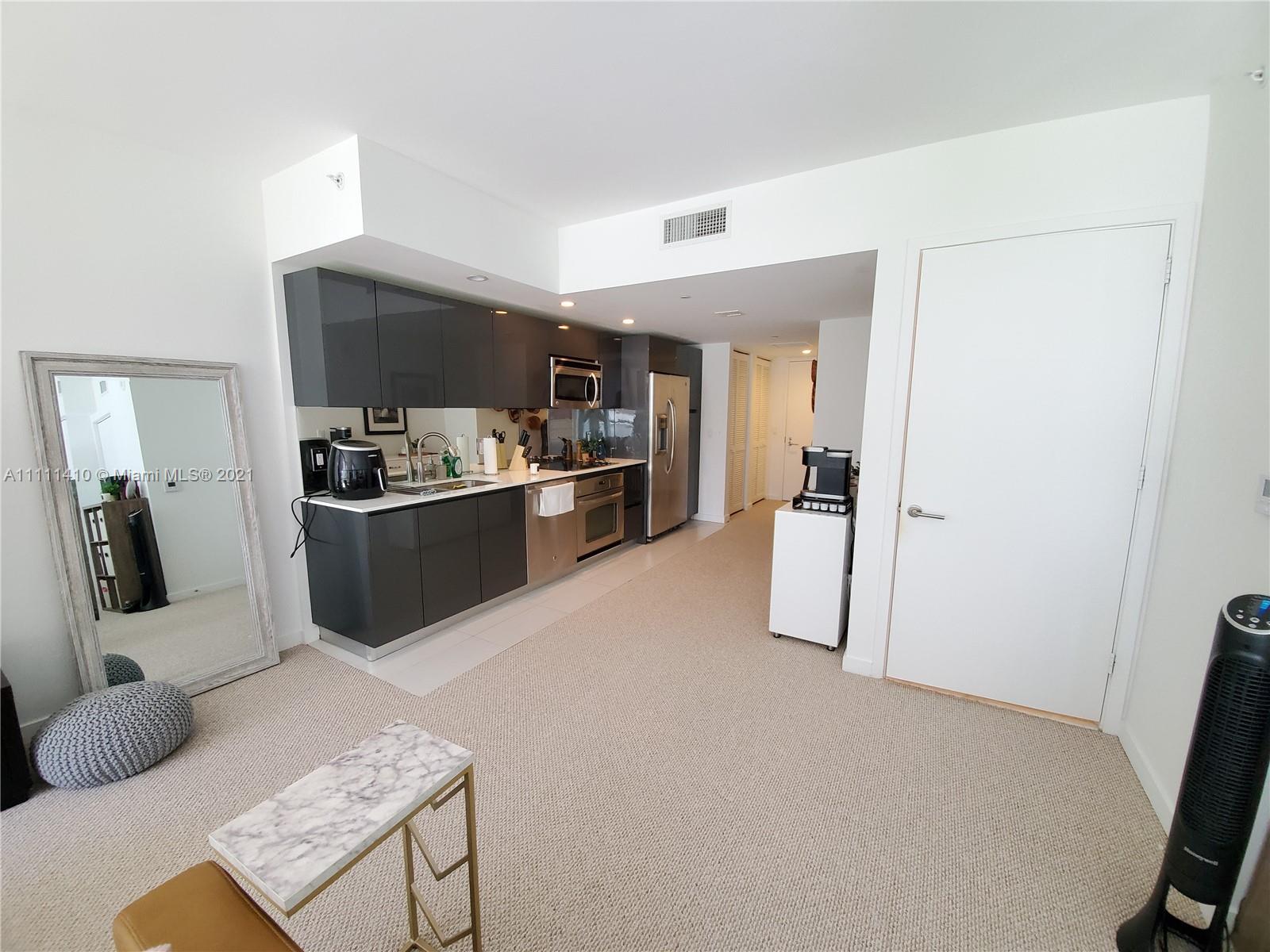 31 Southeast 6th Street, Unit 505 Miami, FL 33131 - Photo 12 of 71 a living room with furniture and a flat screen tv
