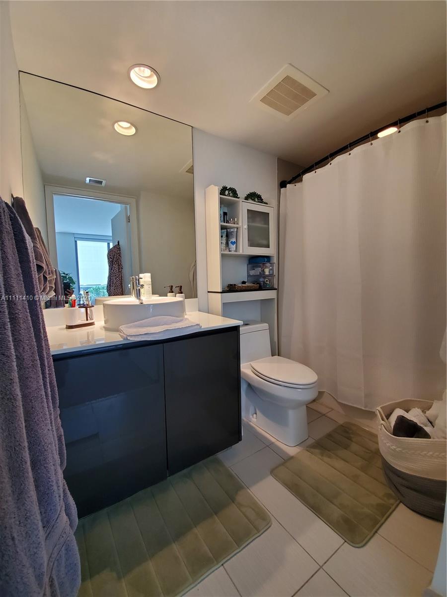 31 Southeast 6th Street, Unit 505 Miami, FL 33131 - Photo 15 of 71 a bathroom with a double vanity sink toilet and mirror