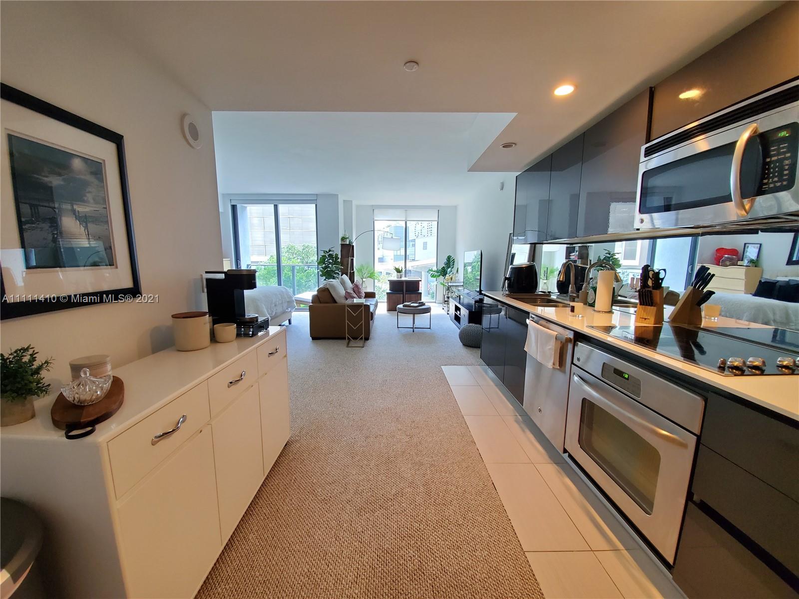 31 Southeast 6th Street, Unit 505 Miami, FL 33131 - Photo 3 of 71 a large kitchen with stainless steel appliances lots of counter top space