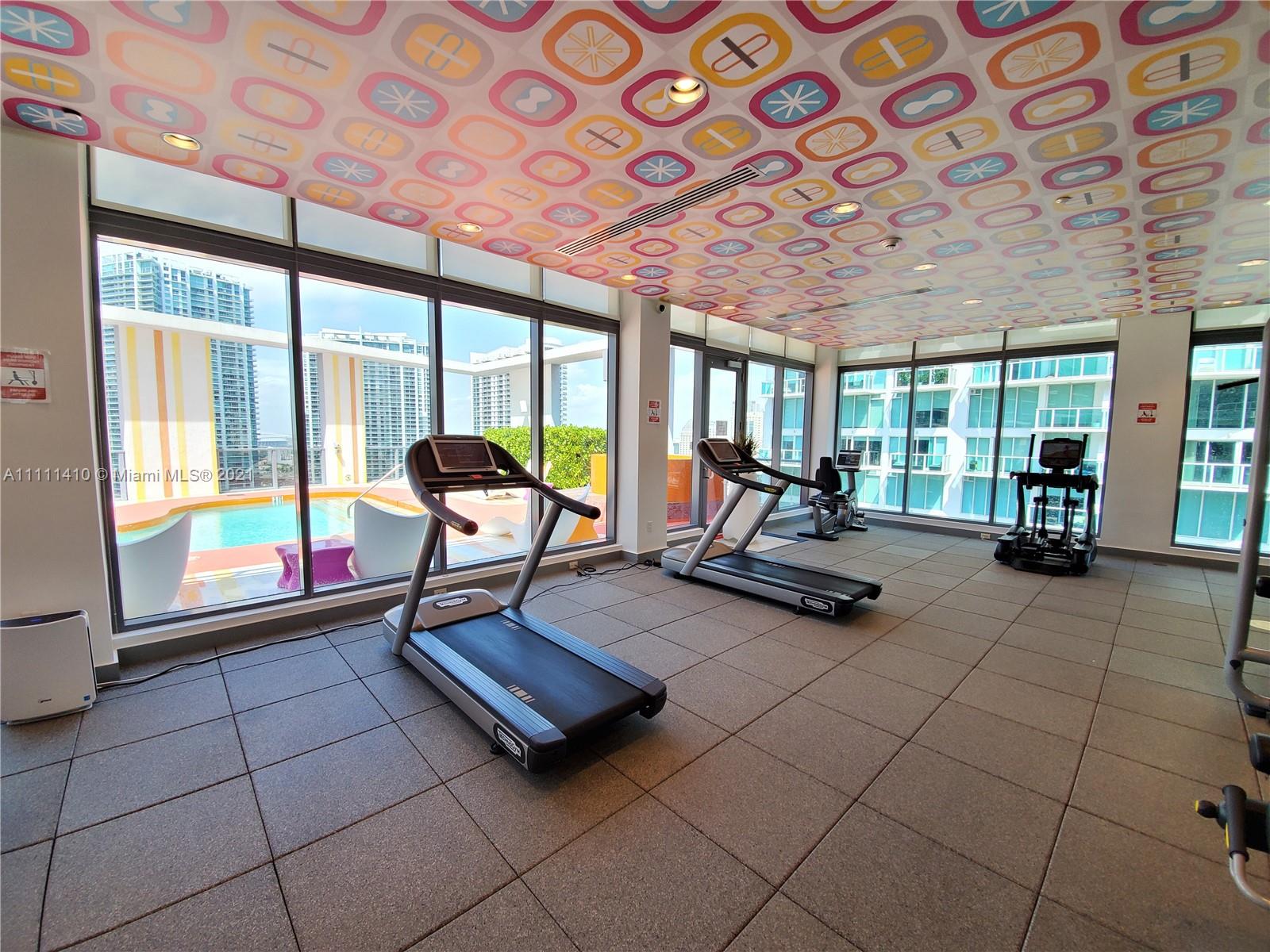 31 Southeast 6th Street, Unit 505 Miami, FL 33131 - Photo 32 of 71 a living room with furniture and large windows