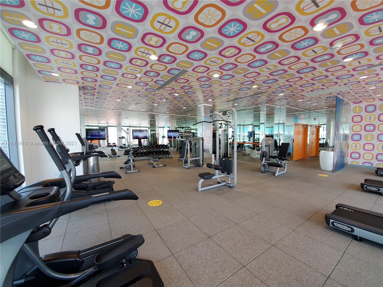 31 Southeast 6th Street, Unit 505 Miami, FL 33131 - Photo 38 of 71 a room with gym equipment and view of living room