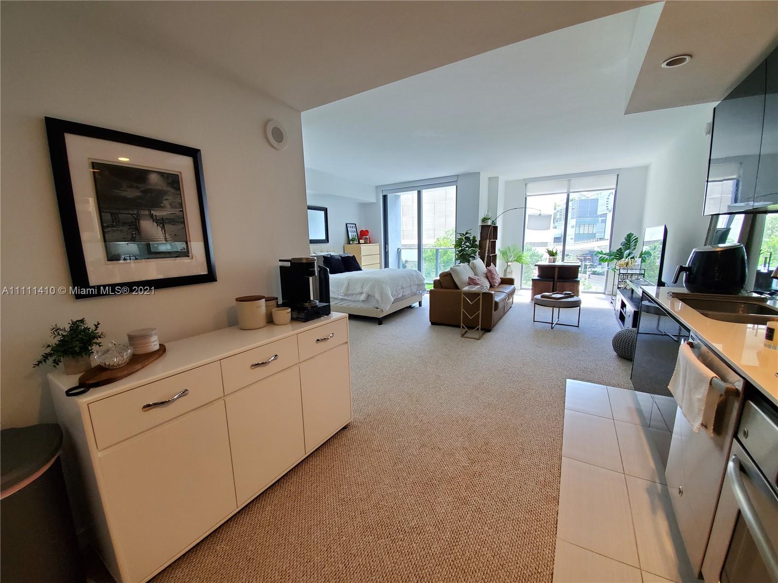 31 Southeast 6th Street, Unit 505 Miami, FL 33131 - Photo 5 of 71 a living room with furniture and a flat screen tv