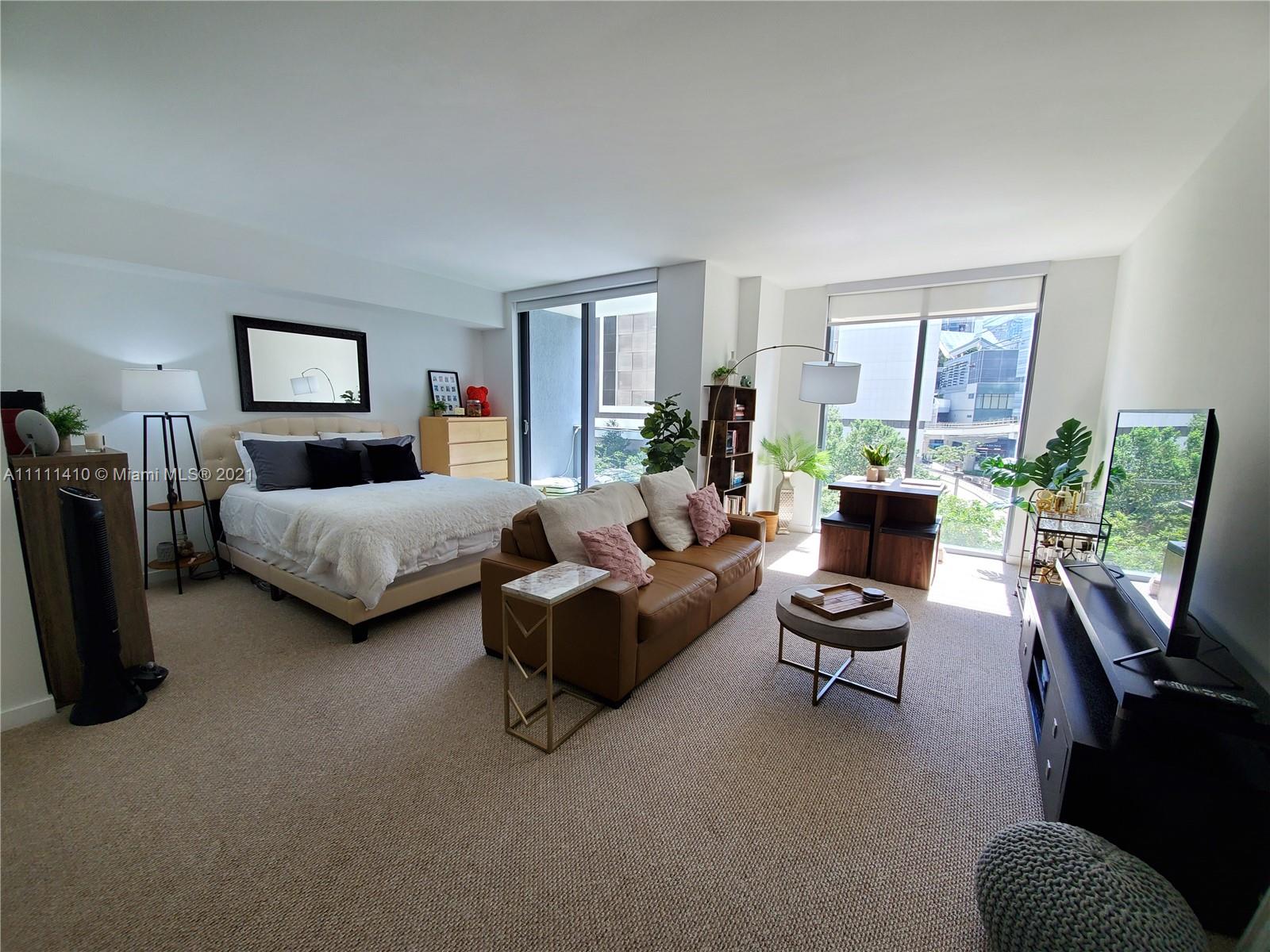 31 Southeast 6th Street, Unit 505 Miami, FL 33131 - Photo 7 of 71 a living room with furniture and a window
