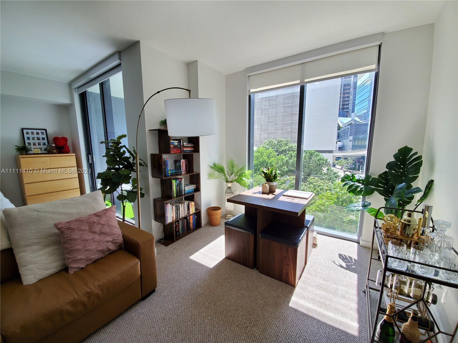 31 Southeast 6th Street, Unit 505 Miami, FL 33131 - Photo 8 of 71 a living room with furniture and a potted plant