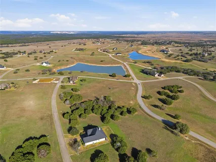 an aerial view of a building with a mountain