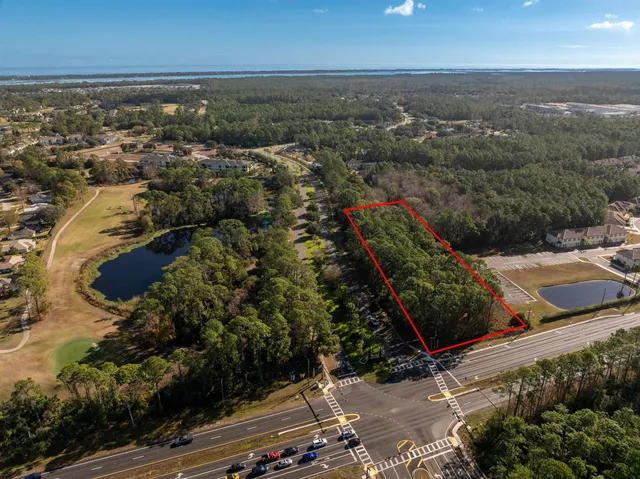 an aerial view of residential building with green space