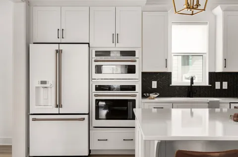 a kitchen with stainless steel appliances a refrigerator and cabinets
