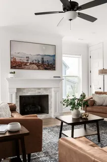 a living room with furniture a table and a fireplace