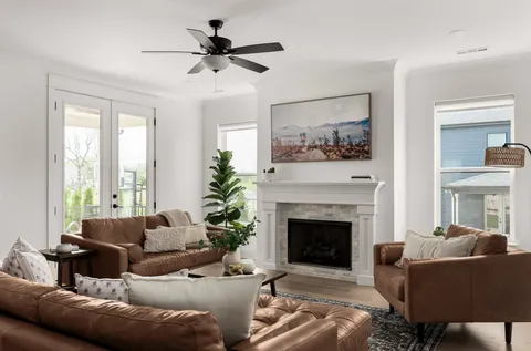 a living room with furniture and a fireplace
