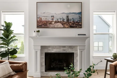 a living room with a fireplace and a large window