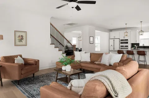 a living room with furniture and wooden floor