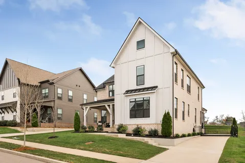 a view of a white house with a yard
