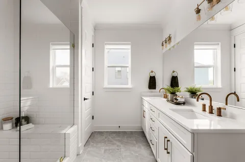 a bathroom with a double vanity sink a mirror and a bathtub