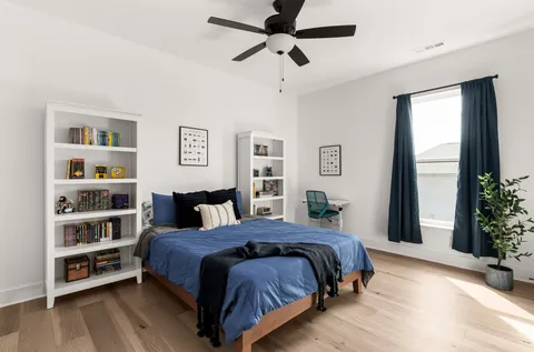 a bedroom with a large bed and a window