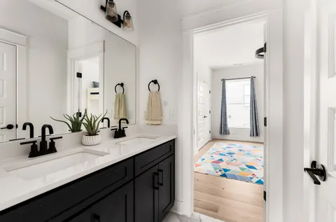 a bathroom with a sink a mirror and a shower