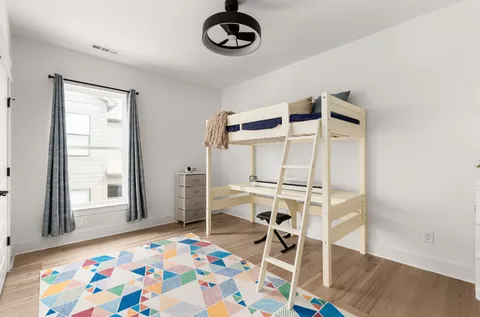 a very nice looking bedroom with a rug and a window