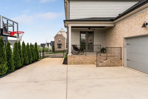 a view of a house with potted plants and floor to ceiling window