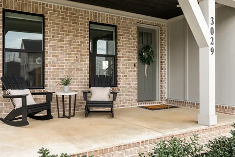 a view of front door of house with outdoor seating