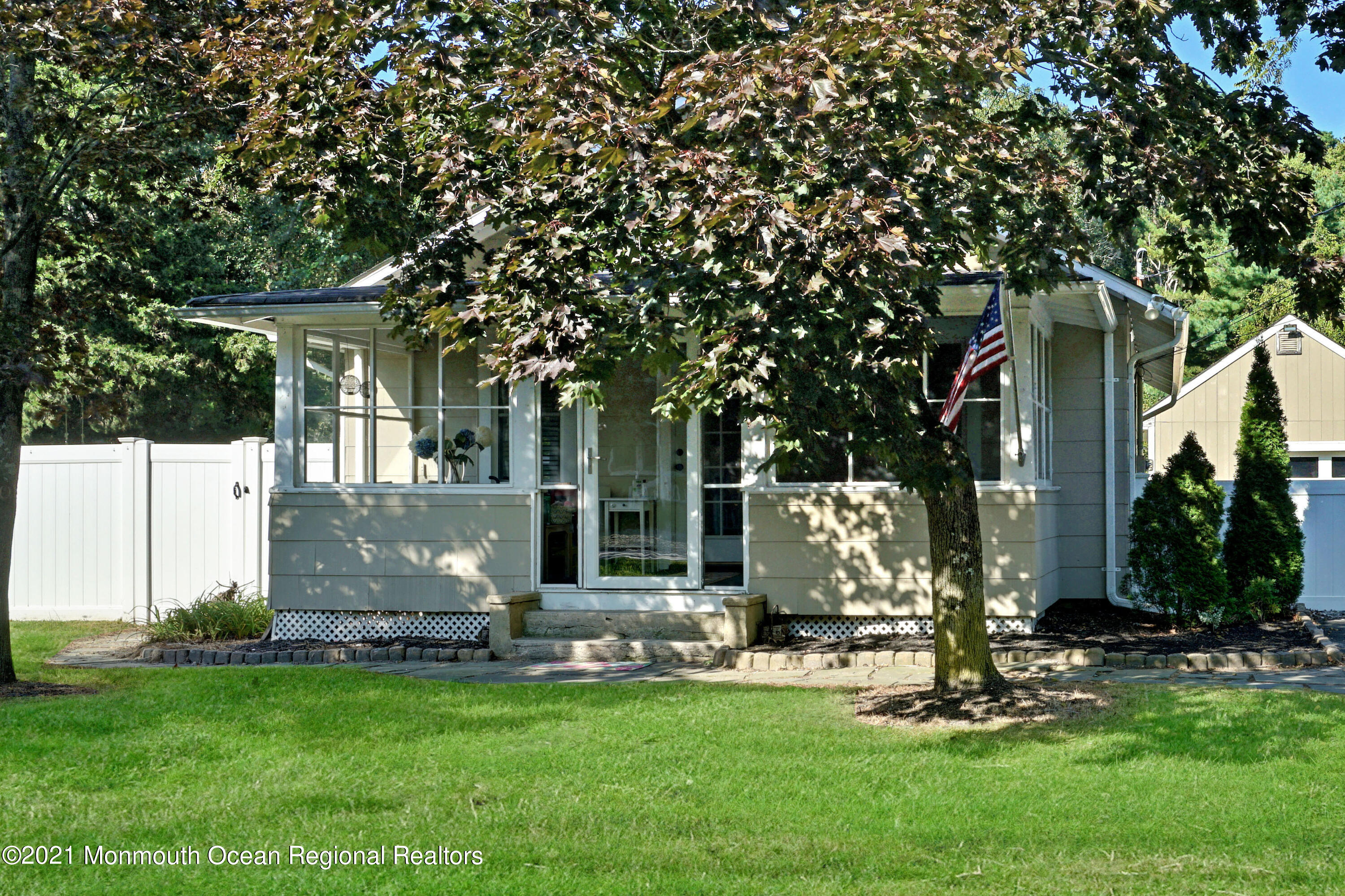 a view of a house with backyard and sitting area