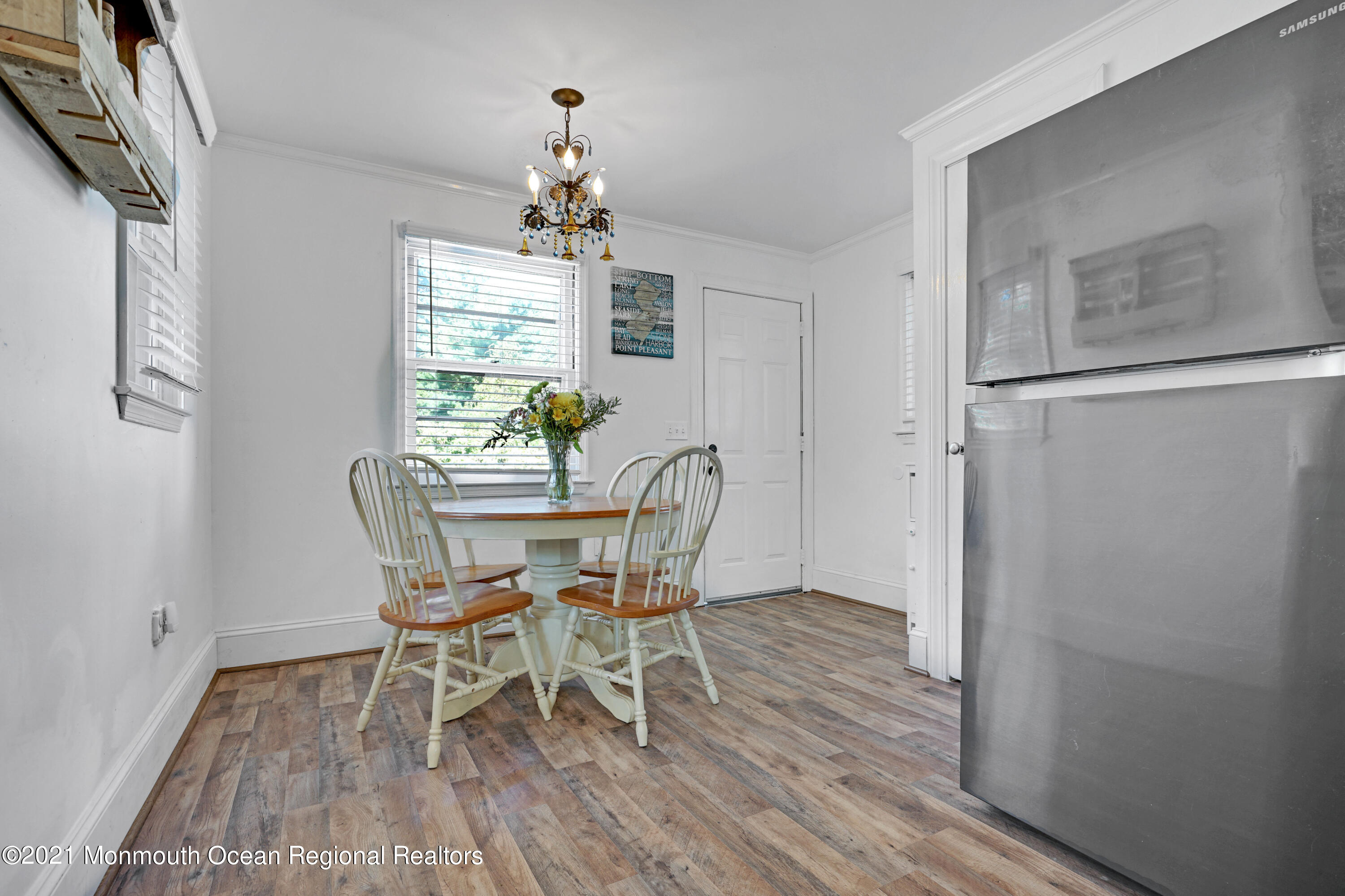 346 Cherry Quay Road Brick, NJ 08723 - Photo 14 of 27 a dining room with furniture a chandelier and wooden floor