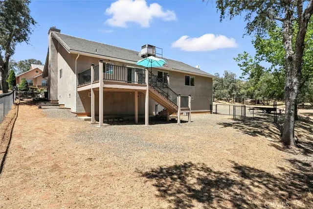 a view of a house with wooden fence