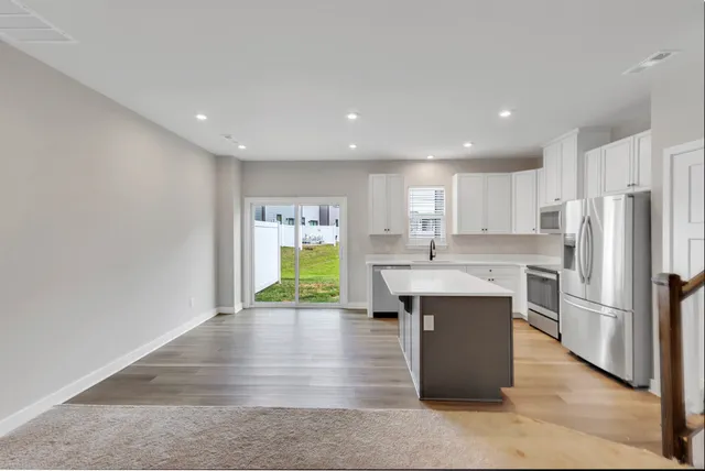 a kitchen with kitchen island refrigerator sink and stove