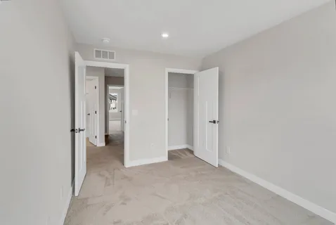 an empty room with closet area