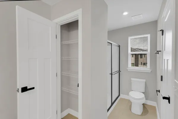 a bathroom with a toilet and a shower