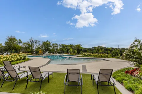 a view of swimming pool with outdoor seating and yard in back