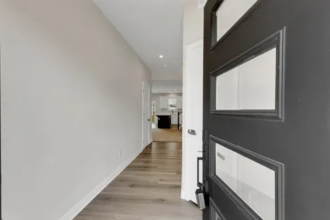 a view of hallway with wooden floor and staircase