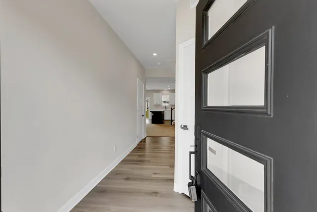 a view of hallway with wooden floor and staircase