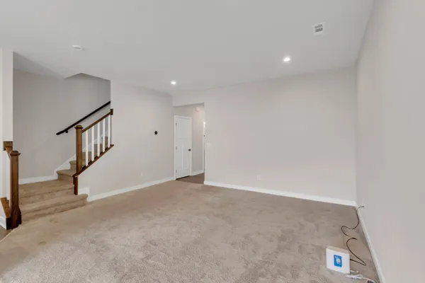 a view of an empty room with stairs