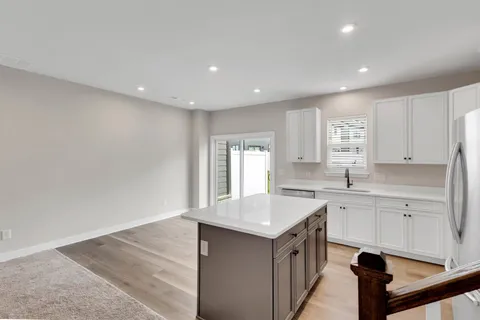 a kitchen with a sink cabinets and window