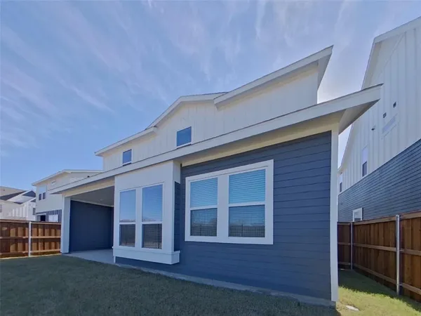 a view of front of house with large windows