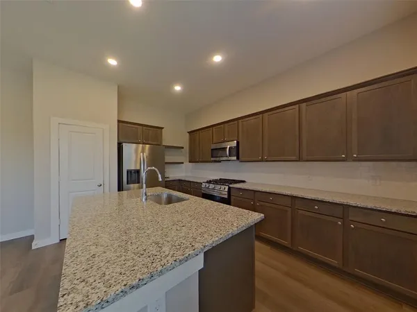 a kitchen with stainless steel appliances granite countertop a sink counter space and cabinets