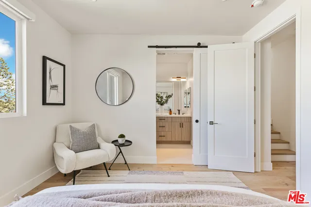 a living room with furniture a mirror and a window