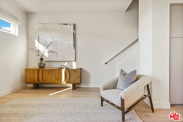 a living room with furniture and a wall